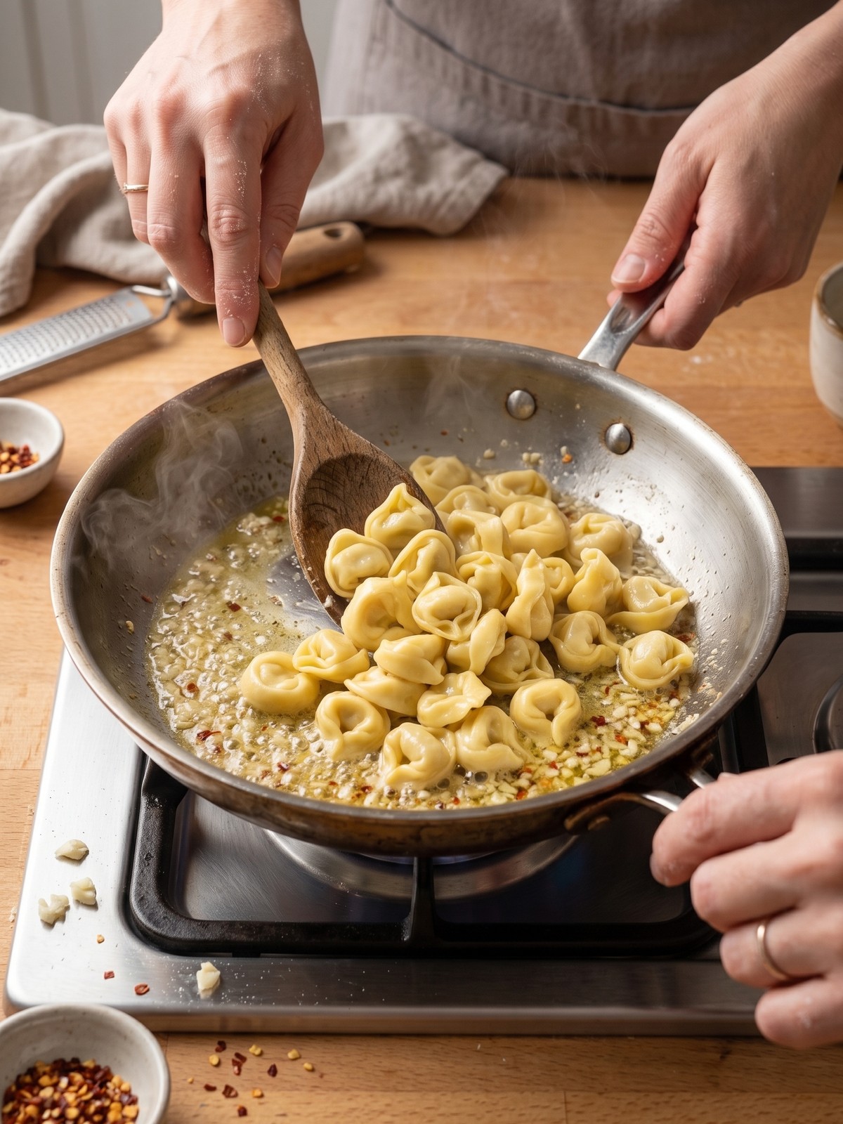 Step-by-step process of making garlic butter tortellini in a skillet.