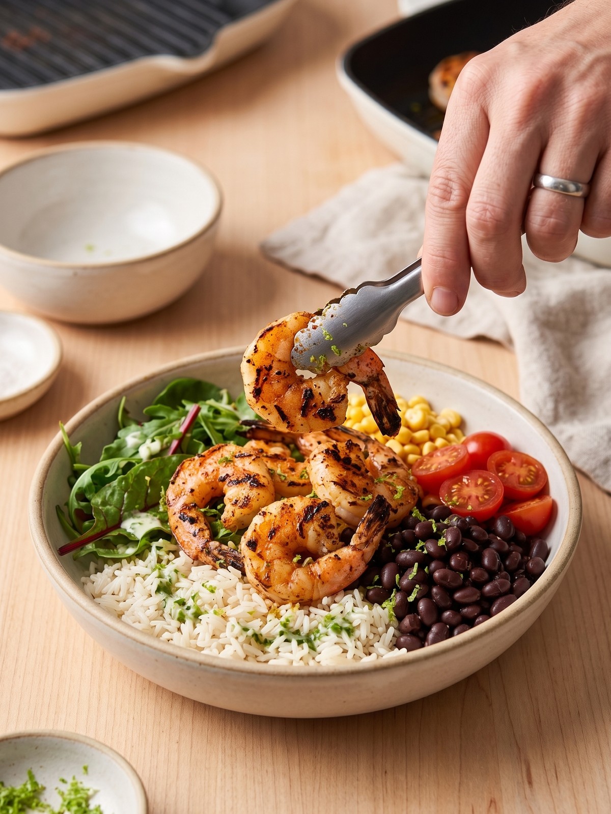 Step-by-step process of grilling shrimp in a cast-iron skillet for a grilled shrimp bowl.